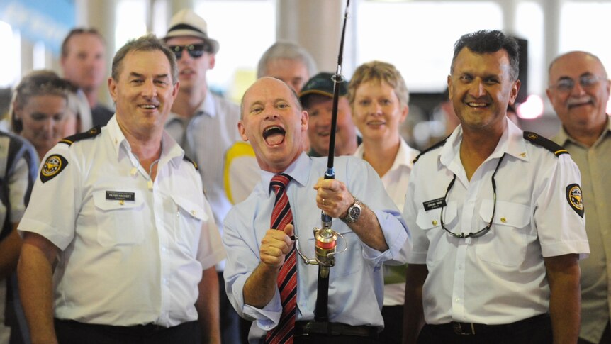 Campbell Newman reels in a 'Virtual Fish' during a visit to an exhibit at the Bait and Tackle show in Brisbane.