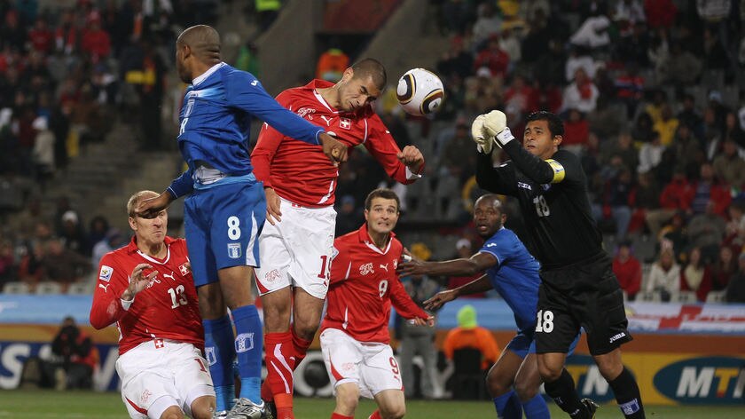 0-0 draw: Switzerland's Eren Derdiyok heads towards goal under pressure from Honduras' Wilson Palacios.