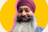 Amar Singh, who wears a turban and has a beard, smiles.