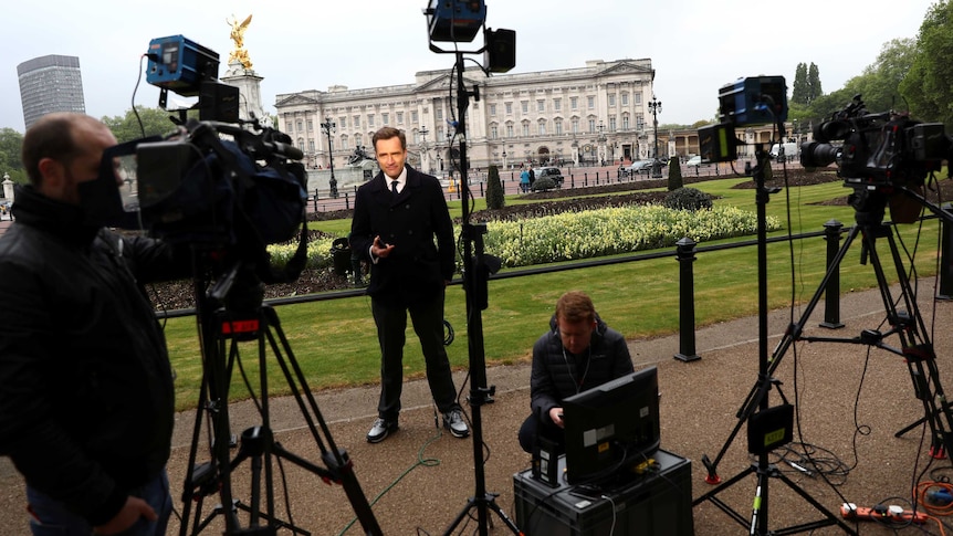 A television journalist reports from outside Buckingham Palace in London, Britain, May 4, 2017.