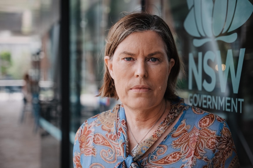 Woman in blue paisley top outside a NSW Government building