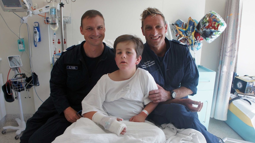 Senior Constable David Crane (left) and Leading Senior Constable Mark Braun (right) with Luke Shambrook at RCH.