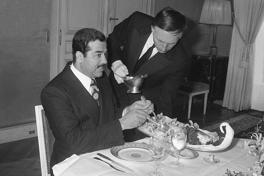 Black and white photo of Saddam Hussein lunching in Paris.