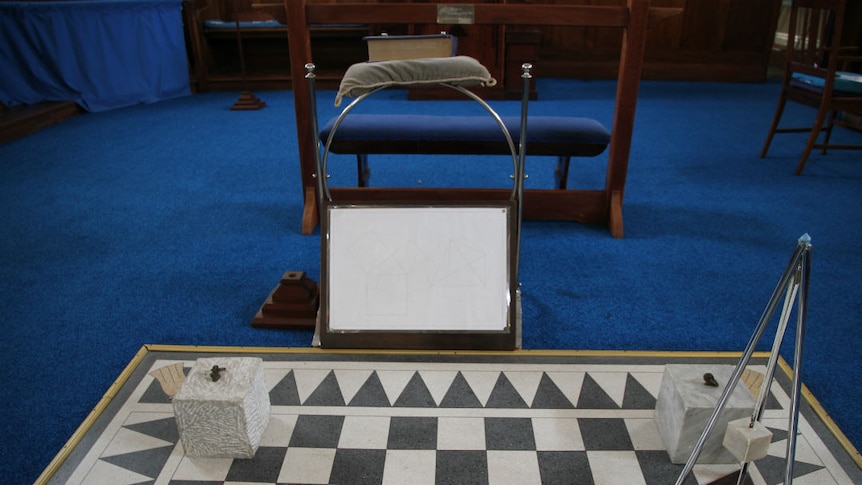Instruments on a chequered board, with blue carpet in the background.