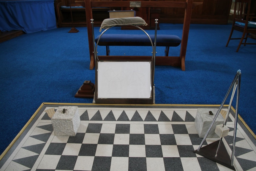 Instruments on a chequered board, with blue carpet in the background.