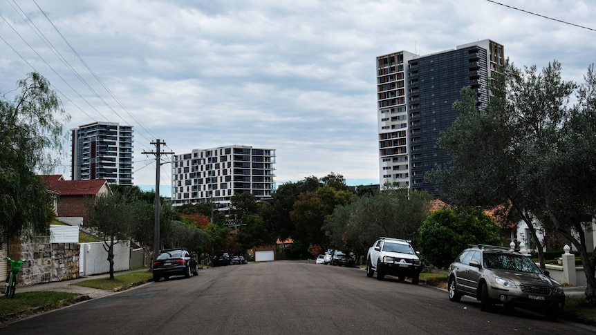 Three tall buildings at the end of a road