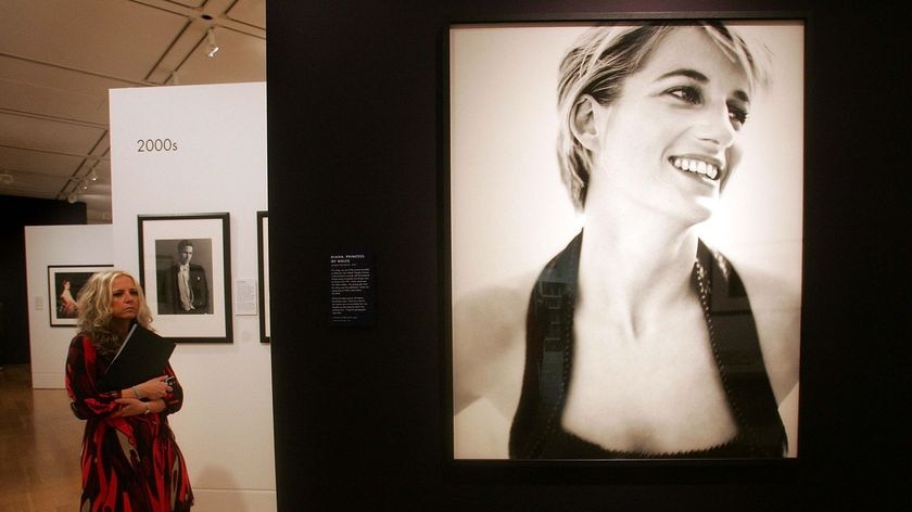 Vanity Fair exhibition: A woman views the Mario Testino portraits on display.