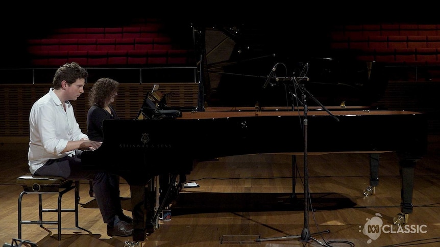 Two pianists playing two pianos