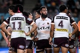 Payne Haas looks dejected, surrounded by teammates, after the Brisbane Broncos concede a try