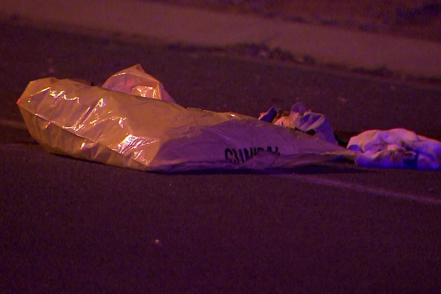 Yellow plastic bag and other items on the ground