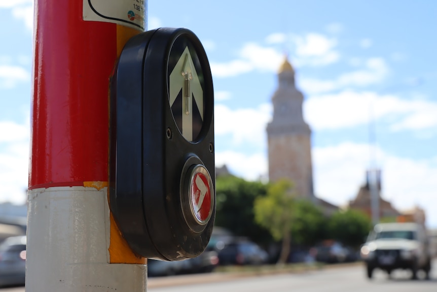 close up of traffic light with building with golden dome in the background.