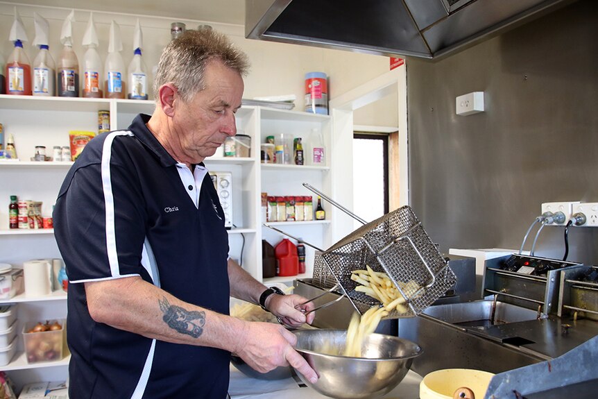 Former TEMCO supervisor Chris Hogan makes chips in his cafe