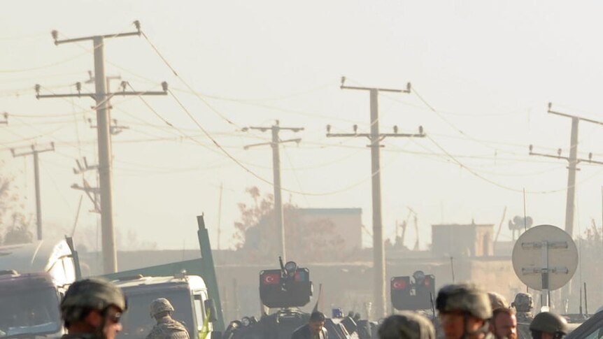 Increasingly bloody: security forces gather at the site of a suicide attack in Kabul on Friday.