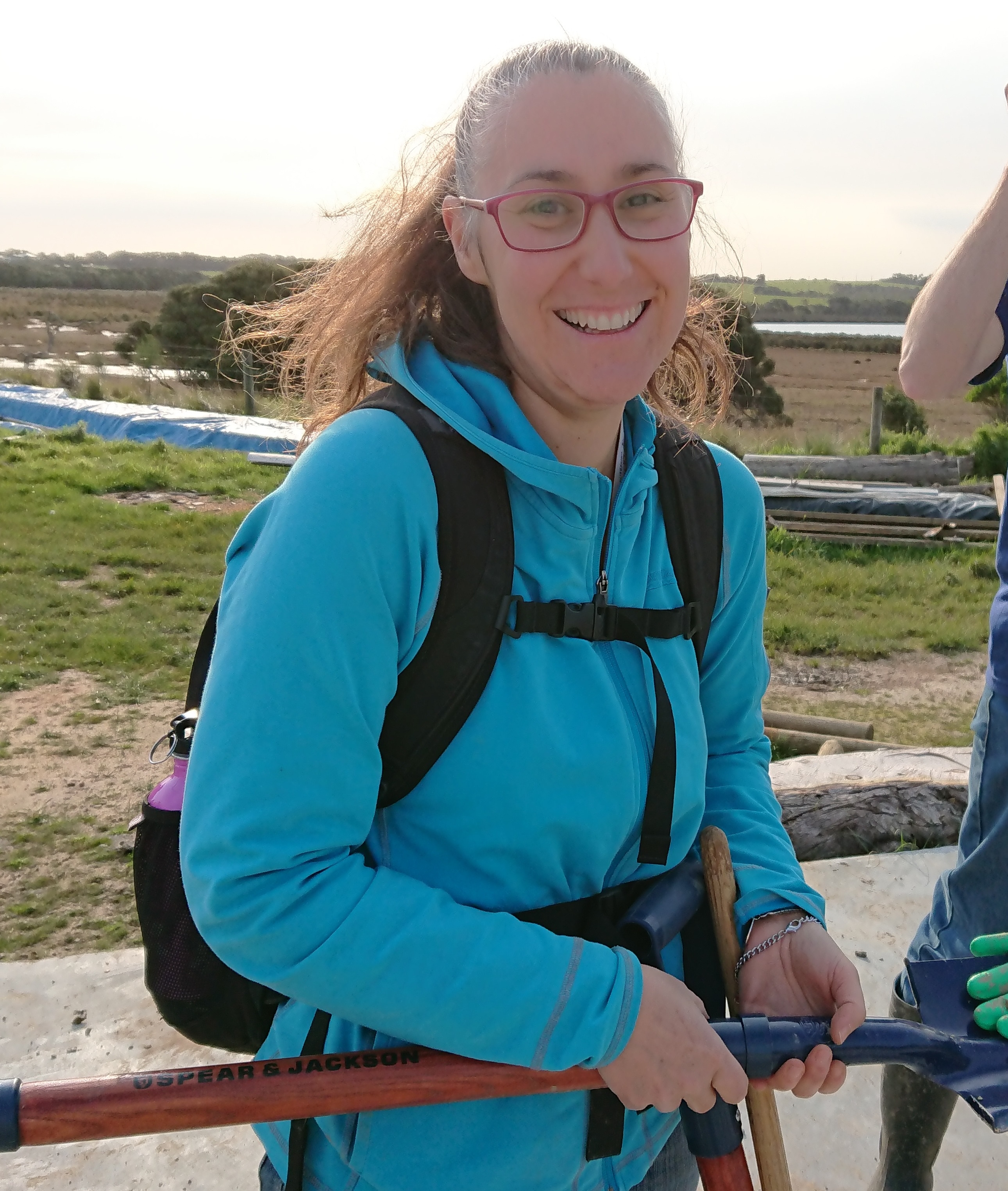 Pavlina McMaster smiles towards the camera while wearing a blue jacket.