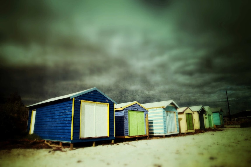 Beach boxes with storm clouds brewing