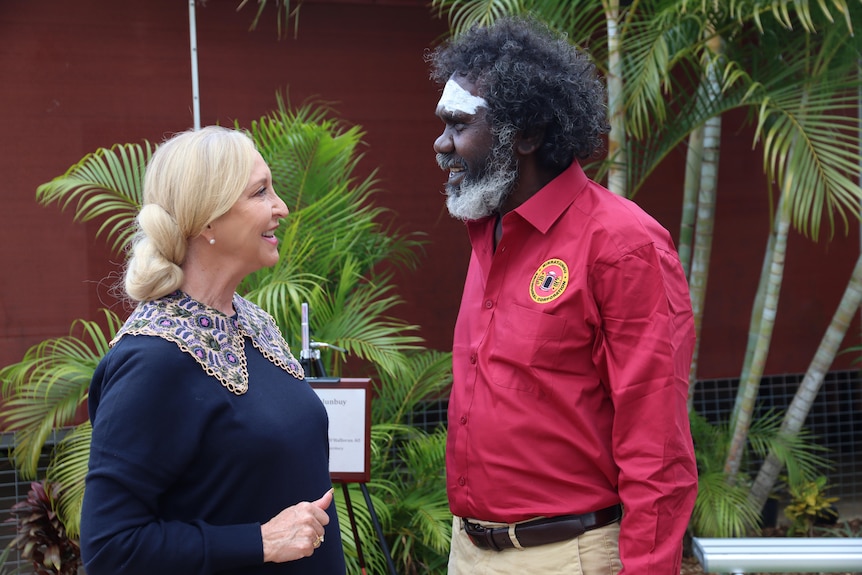 NT Administrator Vicki O'Halloran and a male Aboriginal elder standing and smiling face to face. 