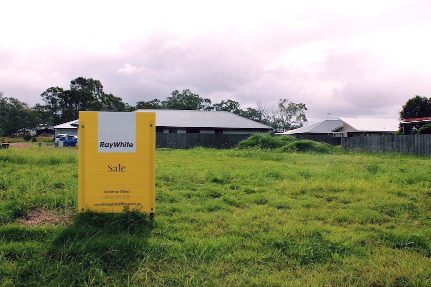 A 'sale' real estate agent sign on an empty block of land in Gladstone.