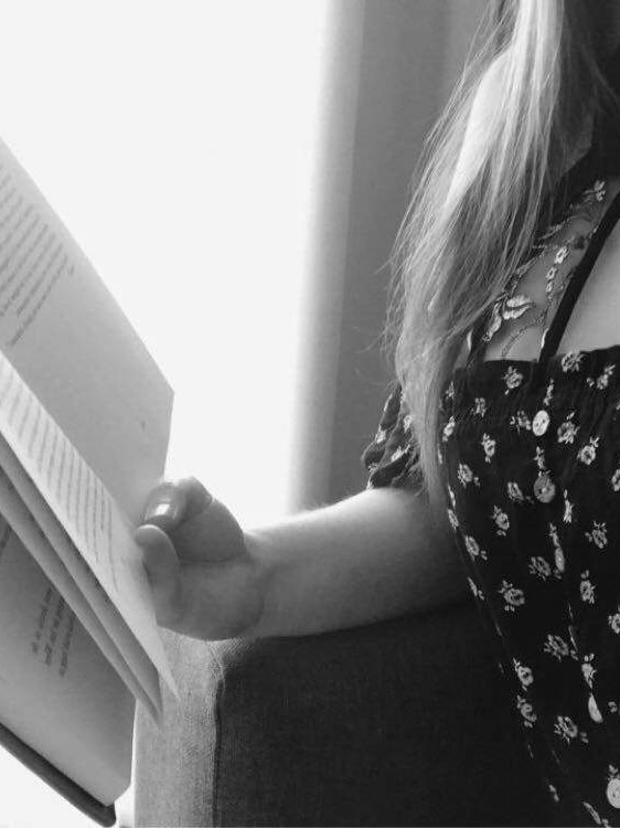 Woman in black and white with book