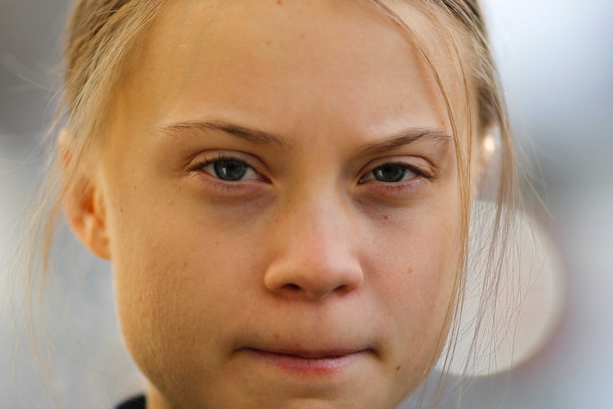 A close up headshot of Swedish climate activist Greta Thunberg