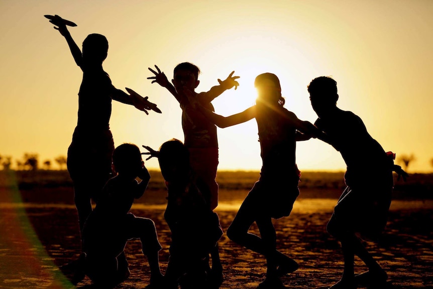 Aboriginal dancers silhouetted