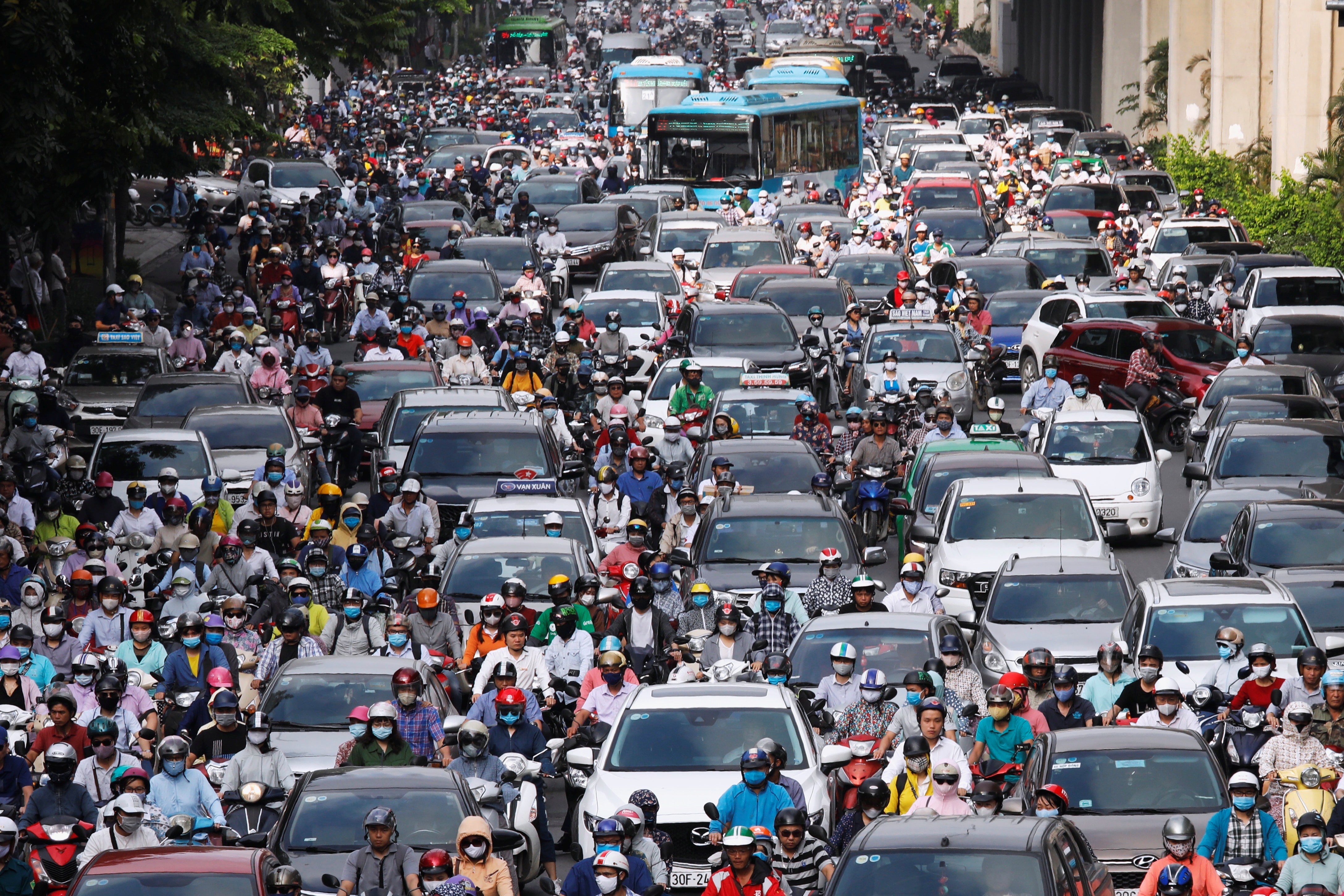 Hundreds of motorbikes, cars and buses in a traffic jam in Vietnam