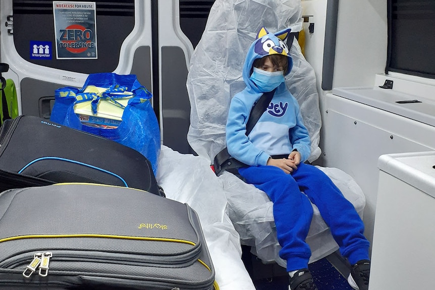 Zen sits in the back of an ambulance.