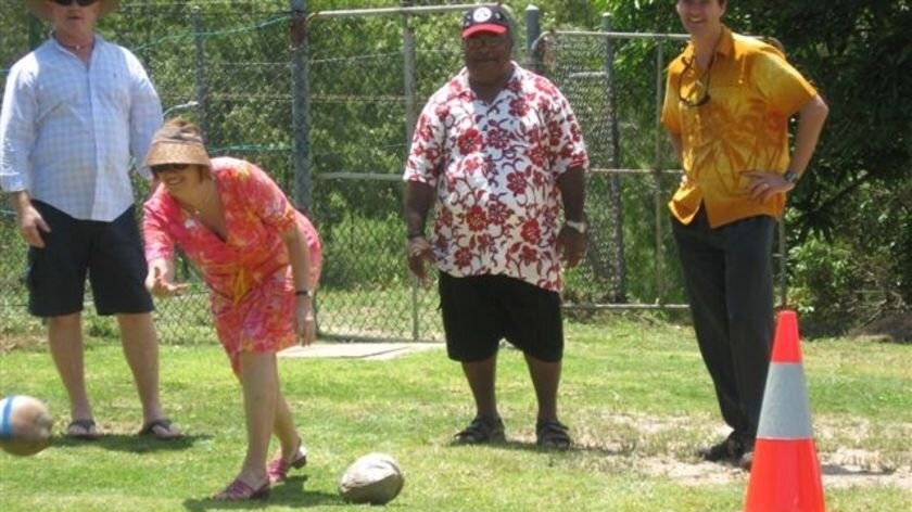 Jenny Woodward tests her skill with coconut bowling on Thursday Island.