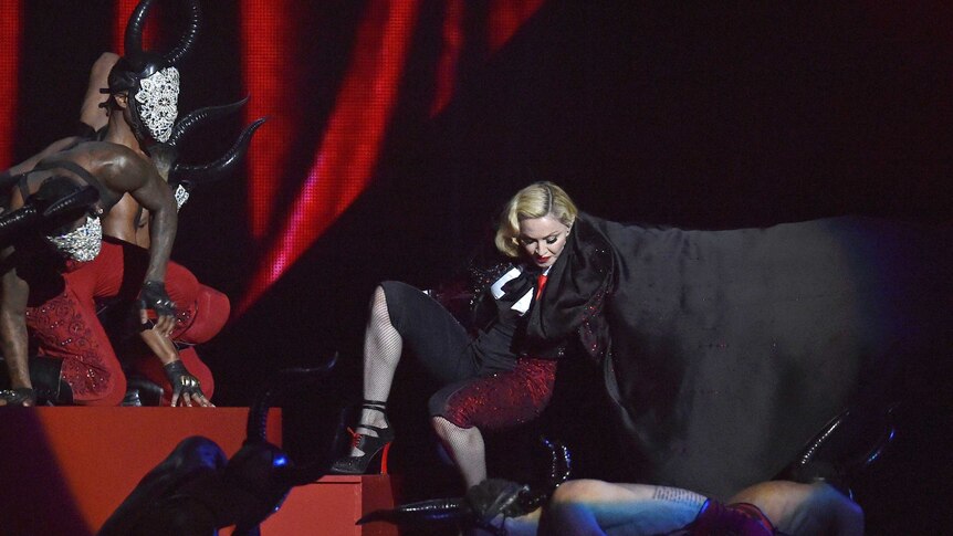 Madonna falls during her performance at the Brit Music Awards