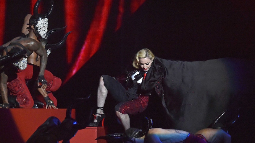 Madonna falls during her performance at the Brit Music Awards