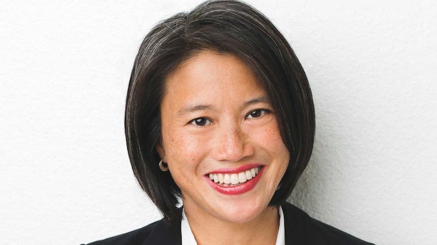 Lisa Leong smiles at the camera, she is wearing a shirt and blazer.