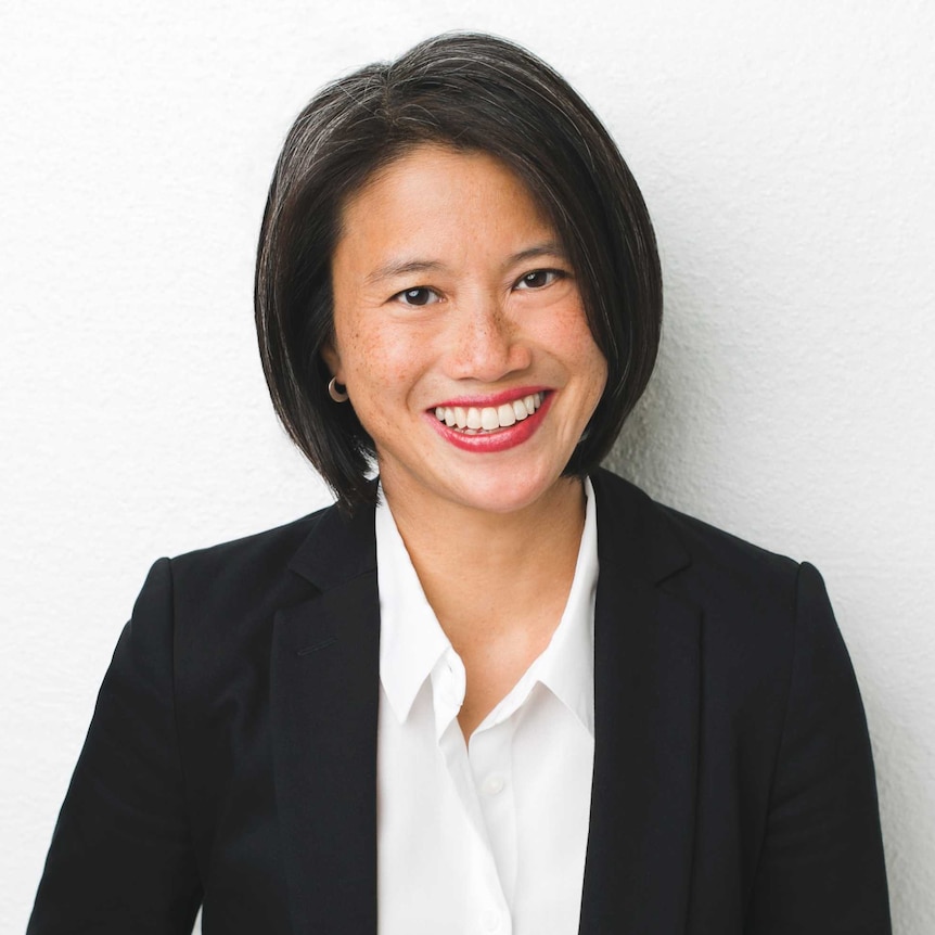 Lisa Leong smiles at the camera, she is wearing a shirt and blazer.