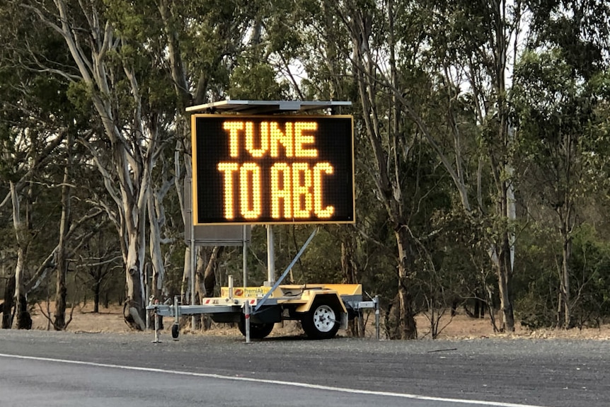 Roadside sign on a trailer saying TUNE TO ABC.