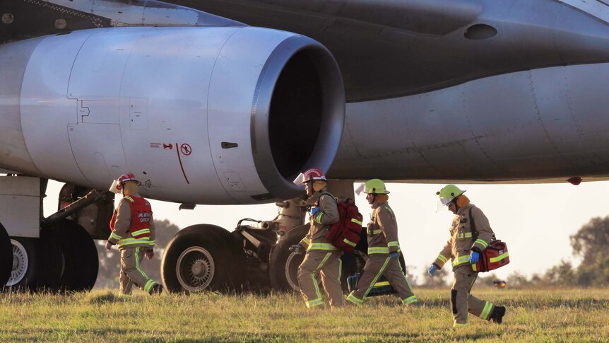 Emergency services at Tullamarine airport inspect an Air Mauritius aircraft