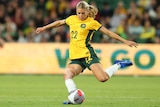 A Matildas player kicks the ball with her left foot in an international.