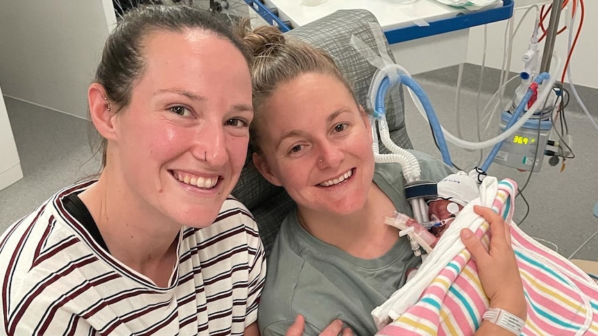 An Australian cricketer with her partner and their newborn baby in hospital.