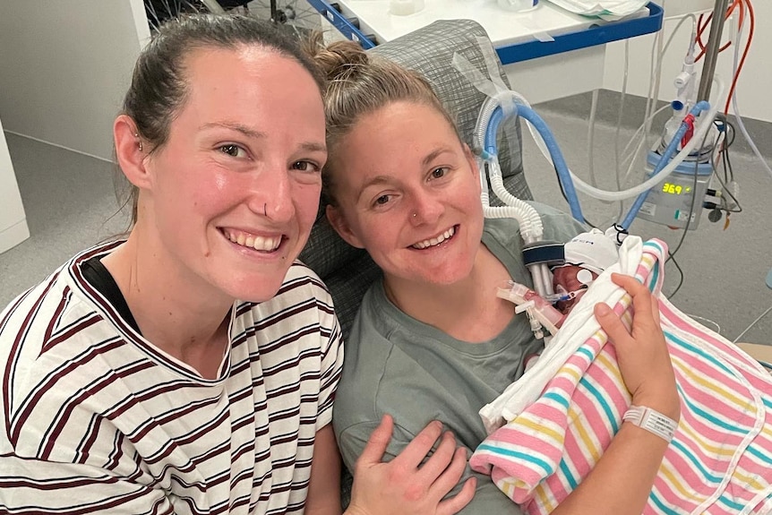 An Australian cricketer with her partner and their newborn baby in hospital.