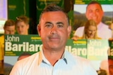 John Barilaro stands in front of election campaign signs