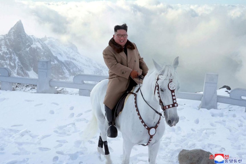 North Korean leader Kim Jong Un rides a horse during snowfall in Mount Paektu