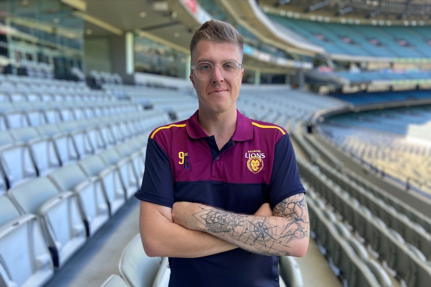 Max Eyking stands with his arms folded at the MCG