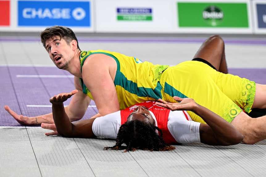 Greg Hire appeals to the umpire after landing on Jaydon Kayne Henry-Mccalla of England