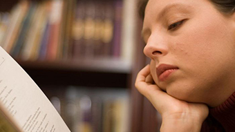 A close up of a woman reading.