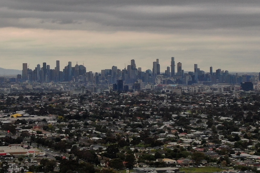 A view of Melbourne's CBD skyline, under hazy grey skies.