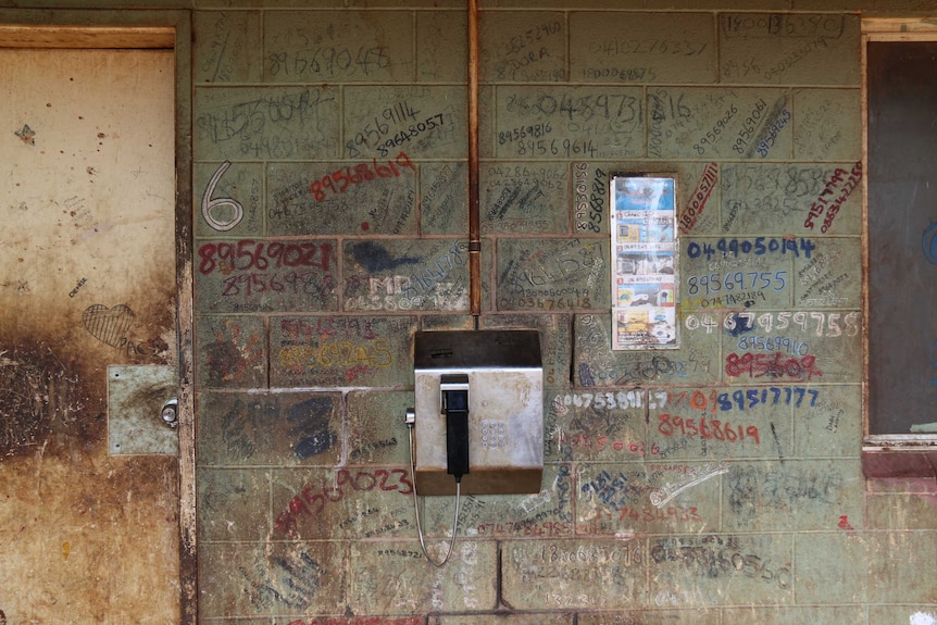 The public phone and a graffitied wall at Camel Camp.