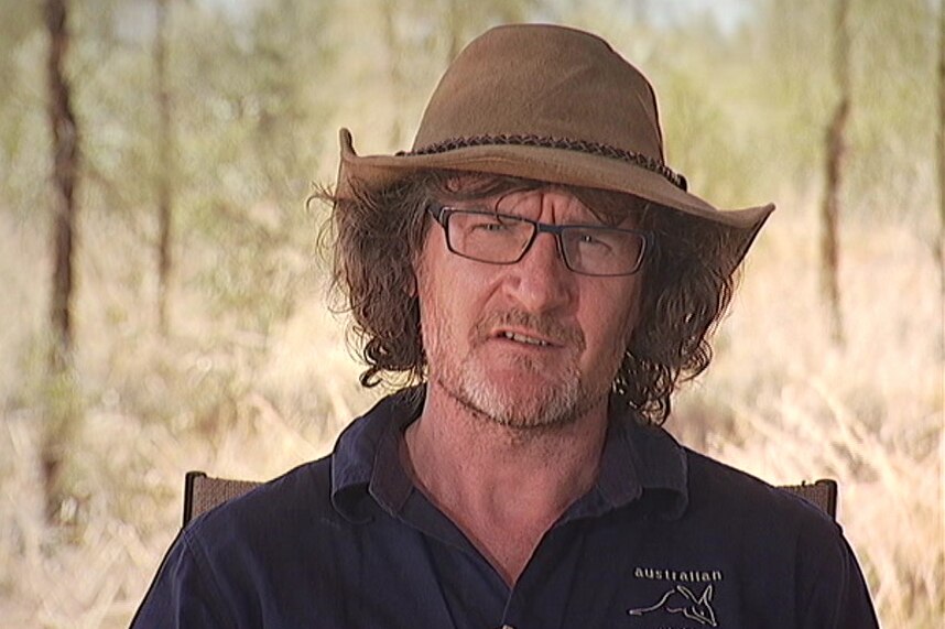 Man talking to camera about feral cats in Northern Territory