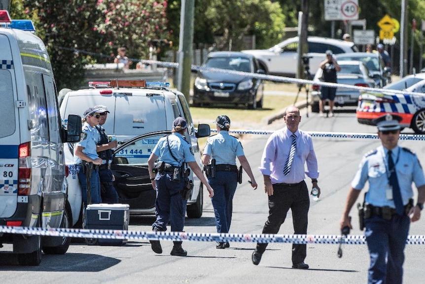 Police officers and police vehicles in a roped off area on Regent Street in Riverstone.