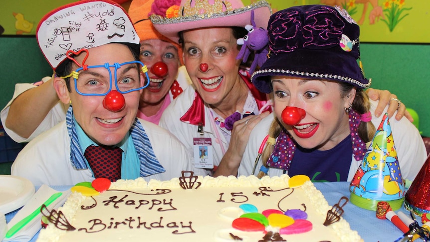 Clown Doctors blow out the candles on a cake celebrating 15 years treating children at the Royal Children's Hospital, Brisbane