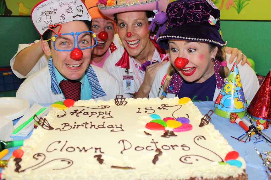 Clown Doctors blow out the candles on a cake celebrating 15 years treating children at the Royal Children's Hospital, Brisbane