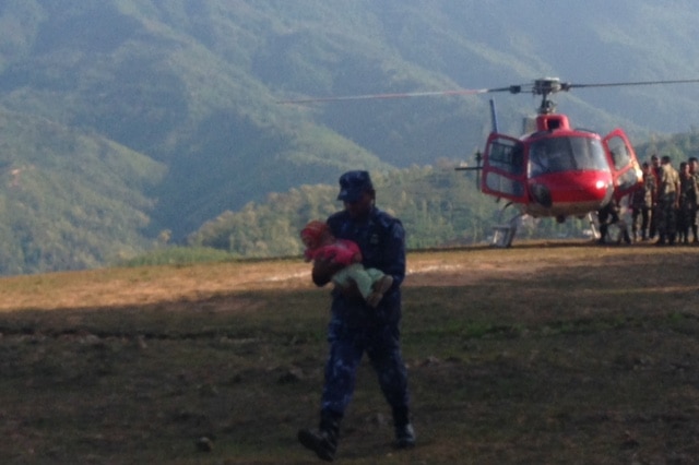 Baby carried from chopper in Nepal