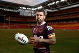 Adam Reynolds poses up in a Broncos jersey 