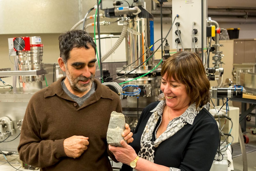 Two fossil researchers holding the stromatolites